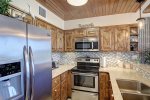 Stunning cabinets and matching appliances with tasteful beach decor